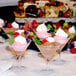 A group of Libbey Mini Martini Glasses with assorted desserts on a table.