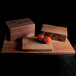 A rectangular faux walnut melamine modular riser with tomatoes on top.