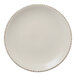 A white Libbey Farmhouse Coupe porcelain plate with brown speckled trim.