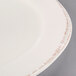 A Libbey round porcelain plate with a white center and brown rim.