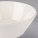 A white porcelain serving bowl with a brown rim.