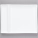 A white rectangular plate with two small square cut outs.