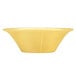 A Libbey round porcelain soup bowl with a yellow surface and gold border.