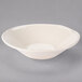 A white Libbey Farmhouse grapefruit bowl with a white border on a gray surface.