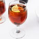 Two Libbey Embassy goblets filled with brown liquid and lemon slices.