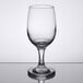 A Libbey white wine glass on a reflective surface.