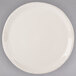 A white Libbey round porcelain platter with a rim.