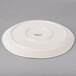 A white Libbey round porcelain platter with a circular rim.