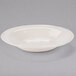 A Libbey Farmhouse white porcelain pasta bowl with a rim on a gray background.