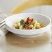 A Libbey white porcelain coupe bowl filled with pasta.