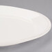 A white Libbey oval porcelain platter with a rim.