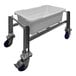 A white plastic container on a stainless steel cart.