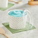 A Choice paper cup with a blue polka dot design and a plastic lid on a counter.