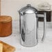 A Frieling stainless steel French press on a counter.