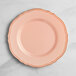 A pink Visions plastic plate with a gold vintage rim.