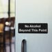 A black and white Lavex sign that says "No Alcohol Beyond This Point" on a door.