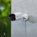 A white Reolink camera mounted on a wall.