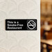 A black Lavex smoke-free restaurant sign with white text on a wall.