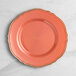 A pink plastic plate with gold vintage trim.