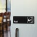 A black and white sign that says "Pull" on a white door.