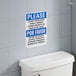 A close up of a toilet with a Lavex Bilingual Safety Label on the wall above it.