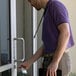 A man using the KEY-BAK Sidekick to hold a plastic badge