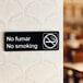 A Lavex black and white sign on a wall that says "No Fumar / No Smoking"