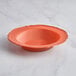 A Visions terra cotta plastic bowl with a gold beaded rim.