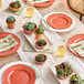 A table set with Visions Terra Cotta plastic bowls with gold rims and succulent plants.