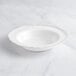 A white Visions plastic bowl with a beaded silver rim.
