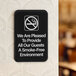 A black rectangular sign with white text that reads "We Are Pleased To Provide All Our Guests A Smoke-Free Environment"