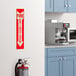 A red and white adhesive safety label that says "Fire Extinguisher" with a down arrow above it.