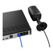 A close-up of a black Reolink network video recorder box with blue cables.
