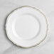 A Visions white plastic plate with gold vintage trim.