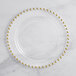 A clear plastic plate with gold beaded rim.