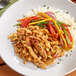 Barvecue shredded plant-based chicken, rice, and vegetables on a plate.