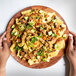 A plate of nachos with Barvecue plant-based shredded chicken, meat, and avocado.