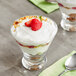 Two glasses of Harmless Harvest plain dairy-free yogurt with strawberries and granola.