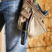 A man wearing a tool belt with a Sharpie Pro Black Chisel Tip Permanent Marker attached.