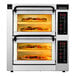 A PizzaMaster electric double deck countertop pizza oven with two pizzas inside.