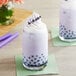 A glass of bubble tea with lavender Taro topping.