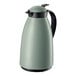 A mint green Cilio insulated carafe with a black handle.