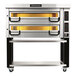 A PizzaMaster electric double deck pizza oven on a stand with yellow trays.