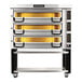 A PizzaMaster electric triple deck pizza oven on wheels.