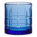 A blue Anchor Hocking rocks glass with a checkered design.