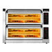 A PizzaMaster electric double deck countertop pizza oven with several pizzas inside.