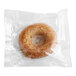 A Southern Roots vegan vanilla glazed cake donut in a plastic bag.