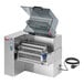 A Sirman Drake automatic meat tenderizer with a meat stripper attachment.