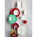 A white Tuxton plate with a berry band on a table with a variety of colorful plates and cups.