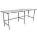 An Advance Tabco stainless steel work table with legs and a white rectangular surface.